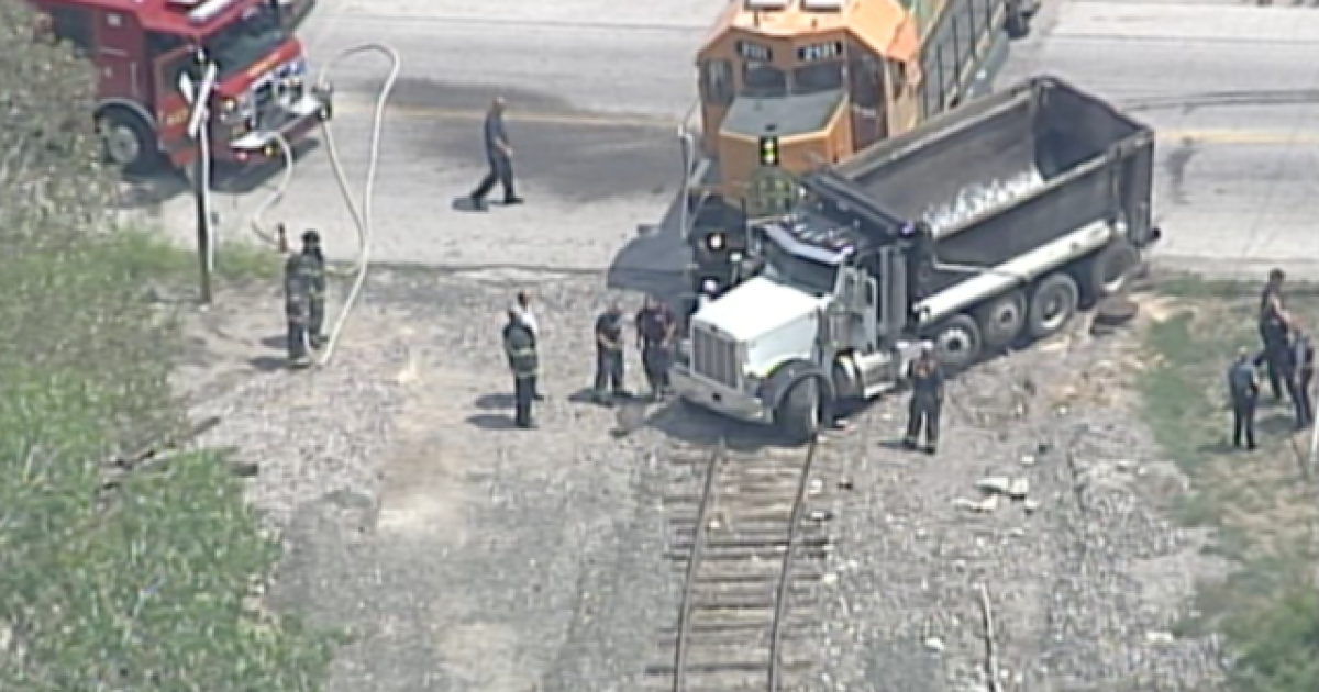 Dump truck can't avoid slowmoving train in KCMO
