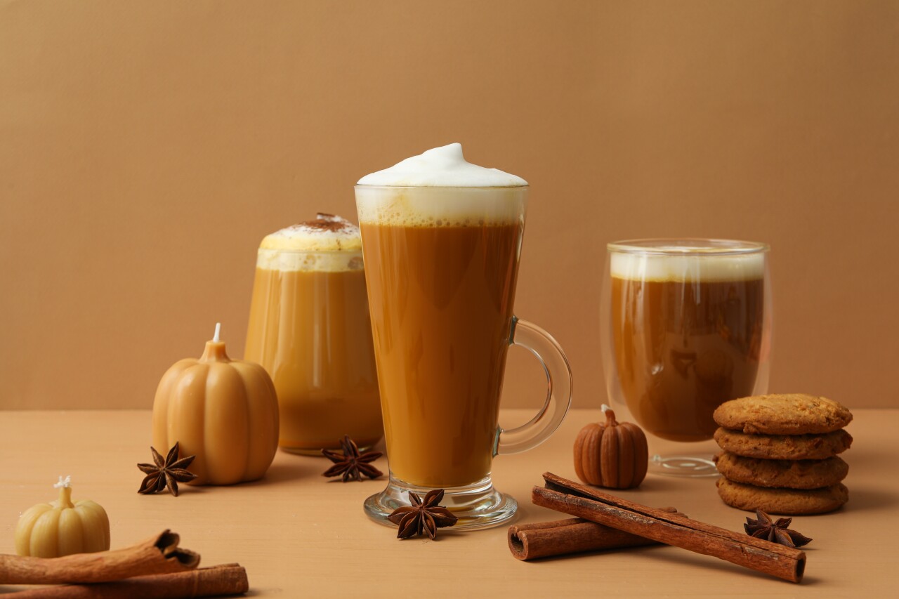 Pumpkin,Coffee,In,Glasses,,Spices,And,Candles,On,Beige,Background