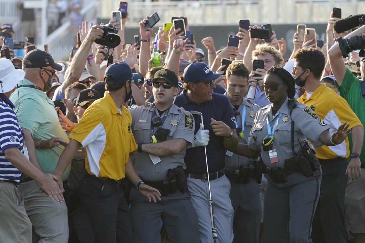 Phil Mickelson tries to get through crowd of fans during final round of 2021 PGA Championship