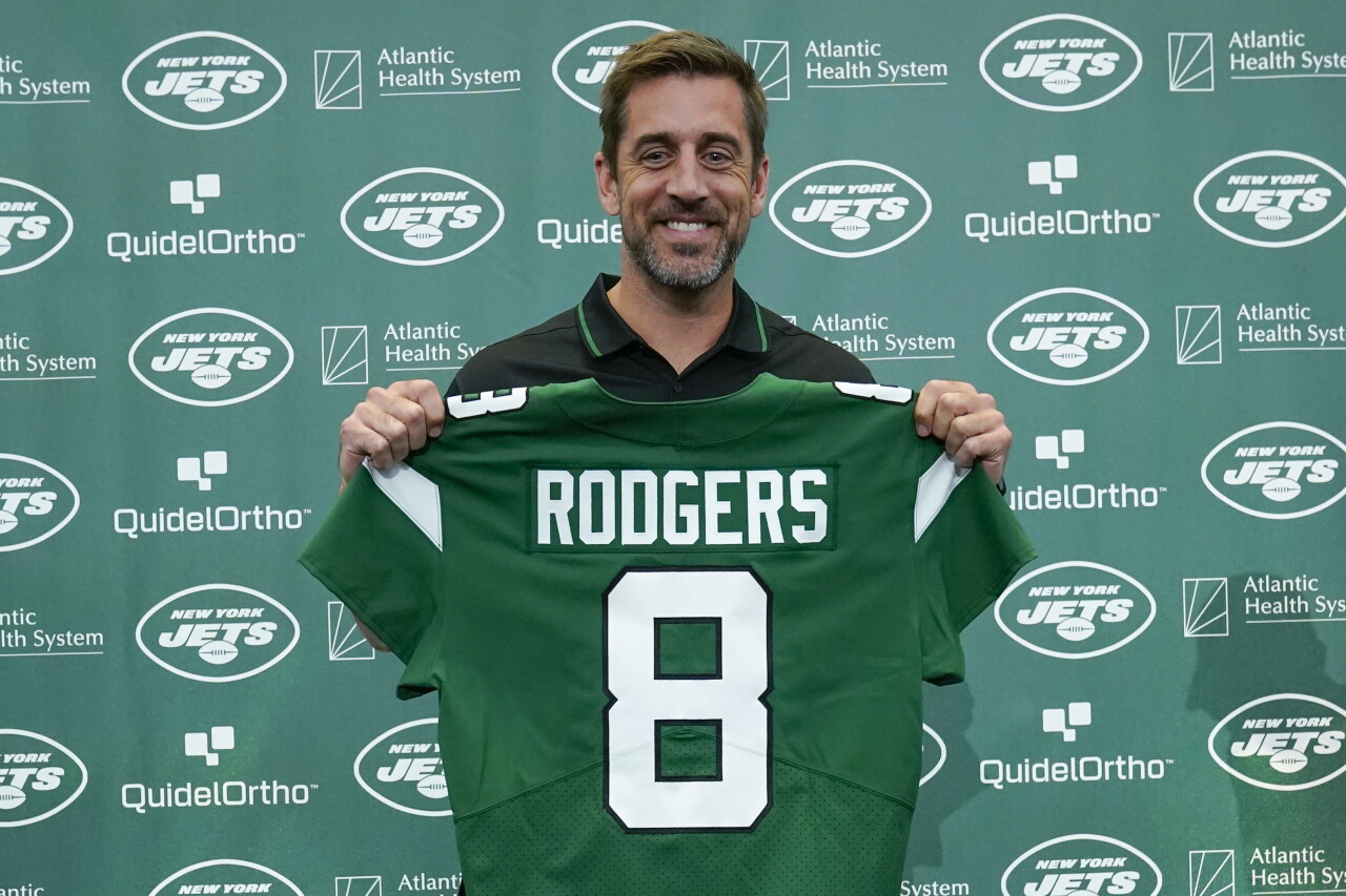 Aaron Rodgers holds New York Jets jersey during introductory news conference, April 26, 2023