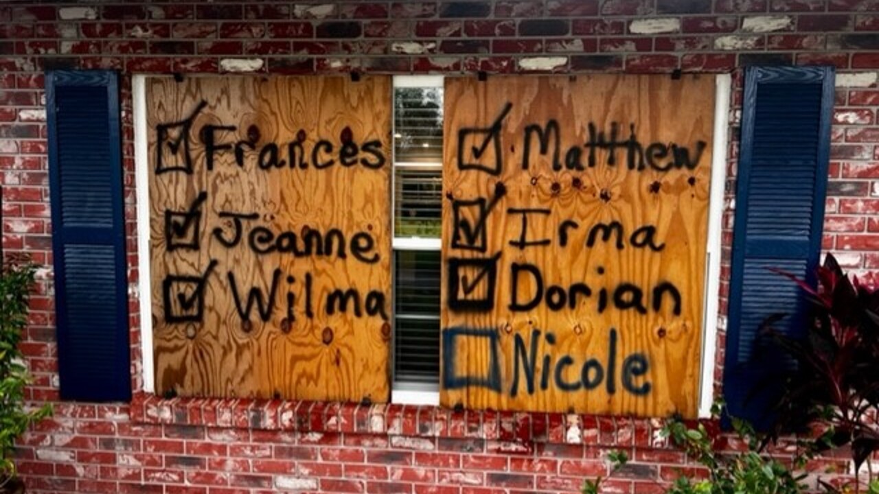 The names of previous hurricanes on a Vero Beach home boarded up for Tropical Storm Nicole, Nov. 9, 2022.jpg