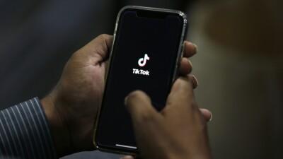 A man opens TikTok on his phone