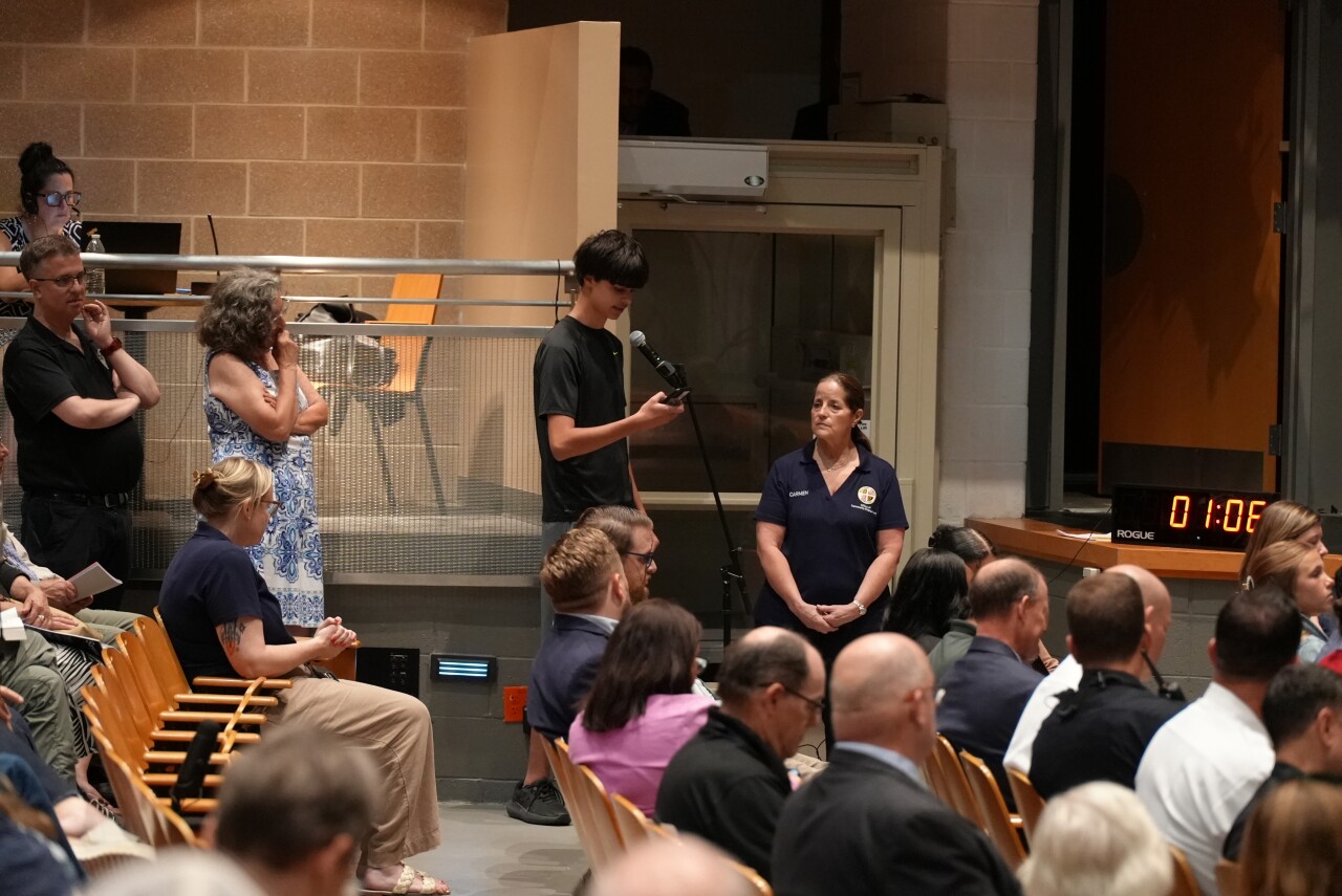 Teenage neighbor sharing his concerns at the public safety town hall