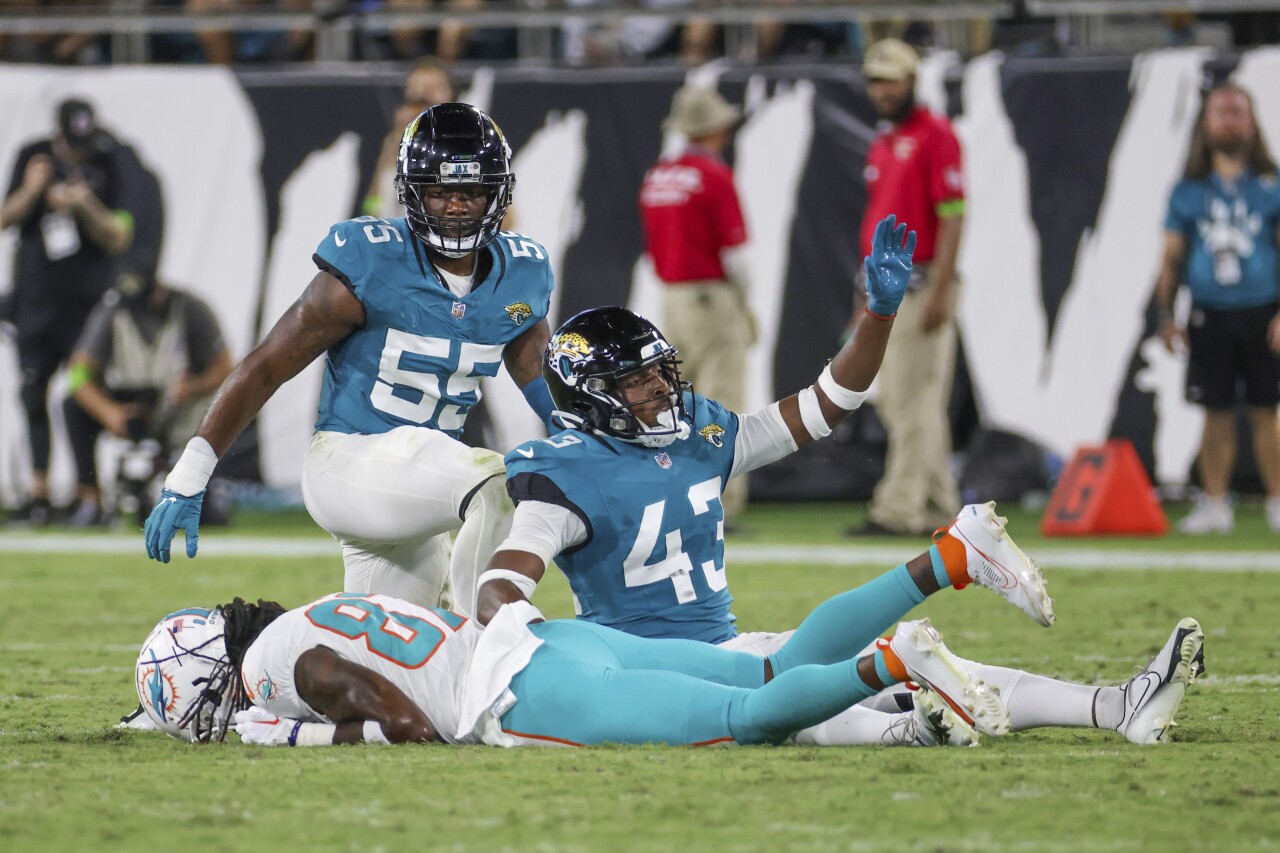 Miami Dolphins receiver Daewood Davis lies face down after being injured by Jacksonville Jaguars linebacker Dequan Jackson as Jacksonville Jaguars cornerback Kaleb Hayes signals for help in fourth quarter of preseason game, Aug. 26, 2023