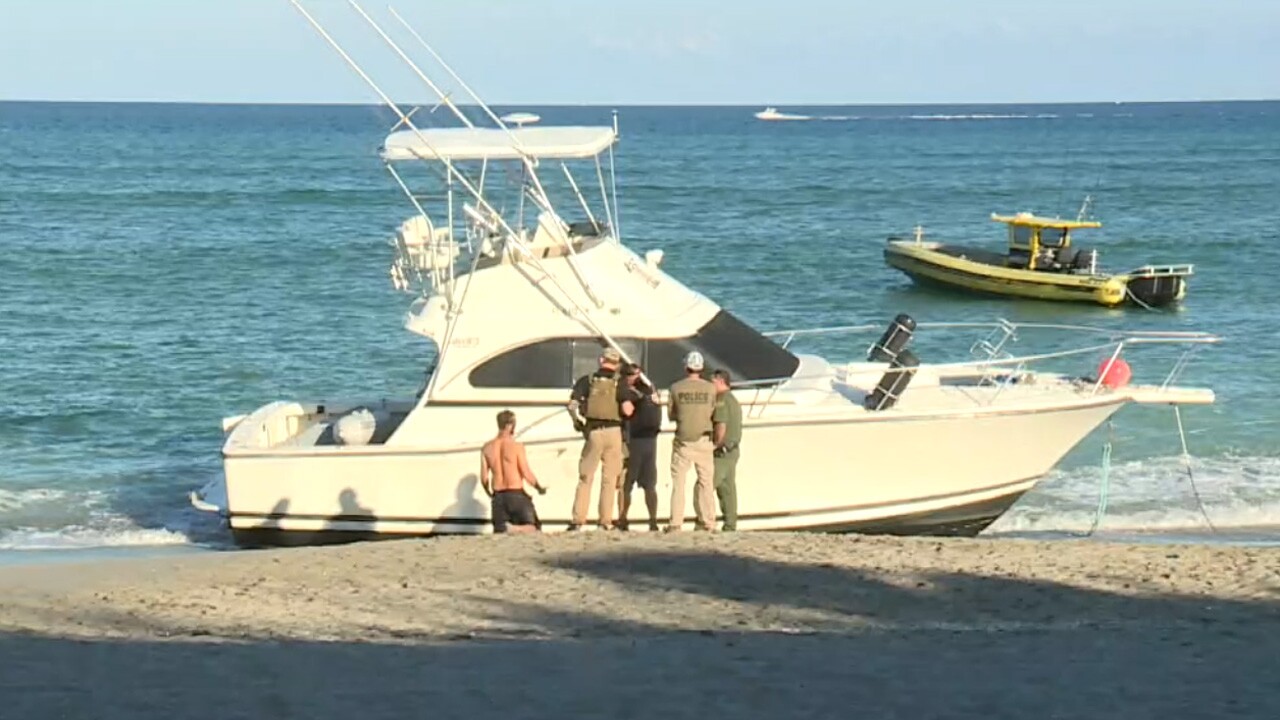 Dozens of migrants scurried ashore from a boat that arrived in Jupiter Sunday.