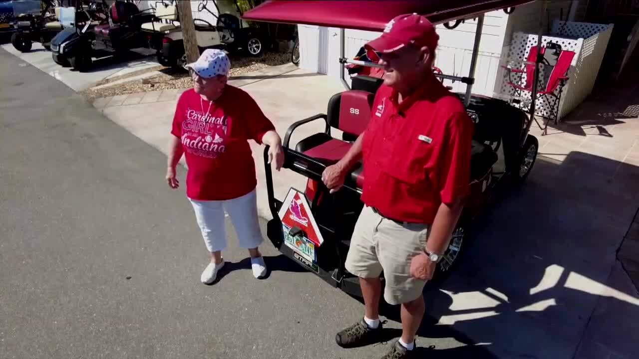 Chris and Kathleen Kinman proudly display Adam Wainwright-autographed golf cart