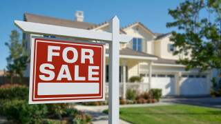 For,Sale,Real,Estate,Sign,In,Front,Of,Beautiful,House.