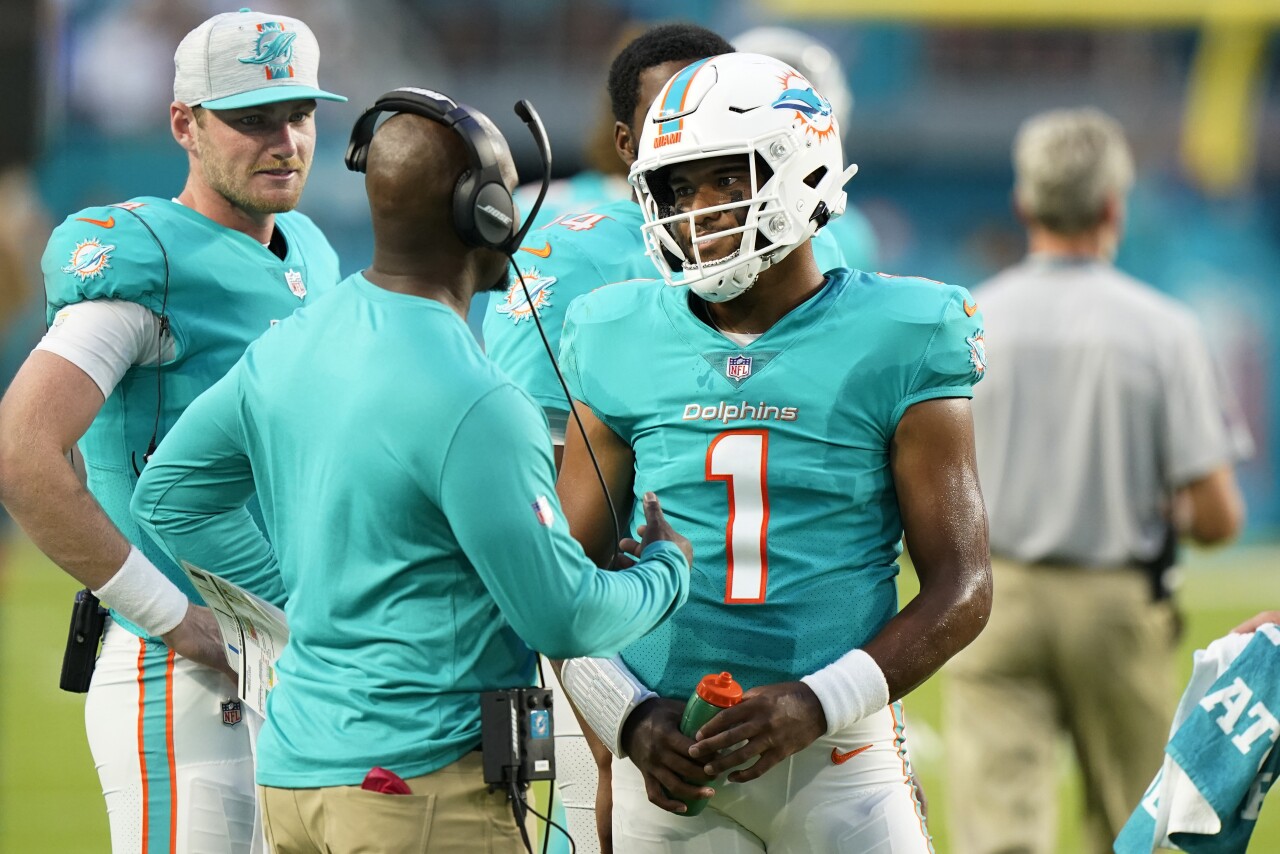 Miami Dolphins head coach Brian Flores speaks to QB Tua Tagovailoa in 2021 preseason game vs. Atlanta Falcons