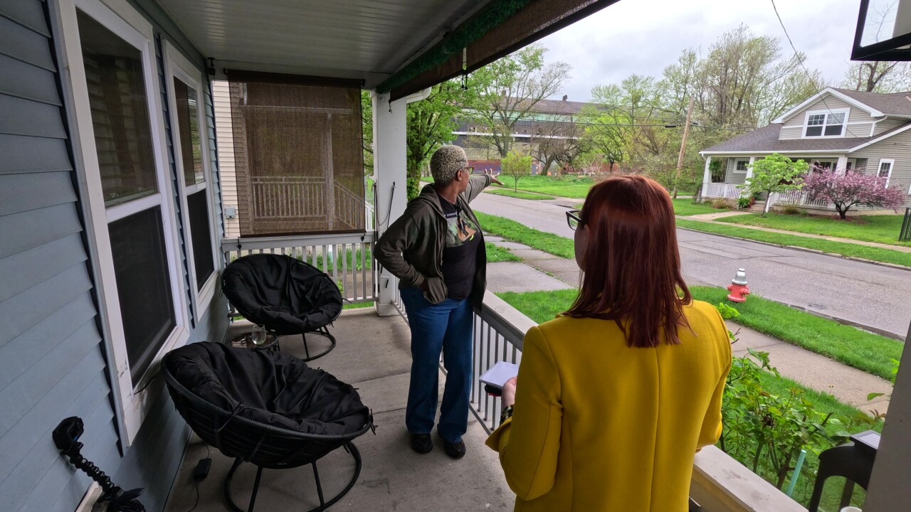 Daanicia Smith-Ayers stands on her porch in Cleveland's Central neighborhood.