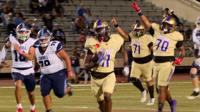 Miller senior Corey Holmes runs over Carroll