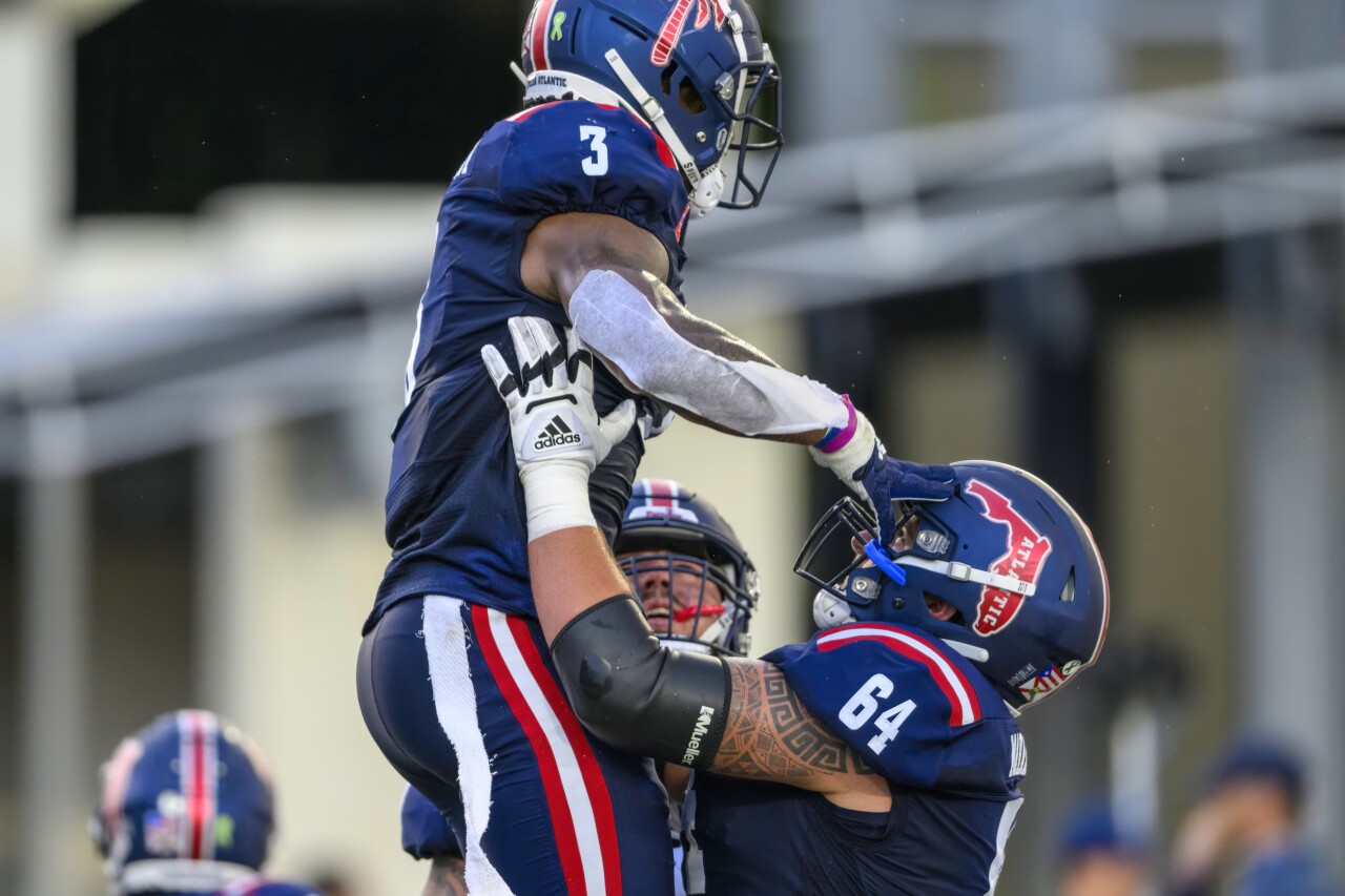 FAU Owls offensive lineman Federico Maranges lifts running back Larry McCammon into the air as they celebrate TD vs. Tulsa Golden Hurricane, Oct. 7, 2023