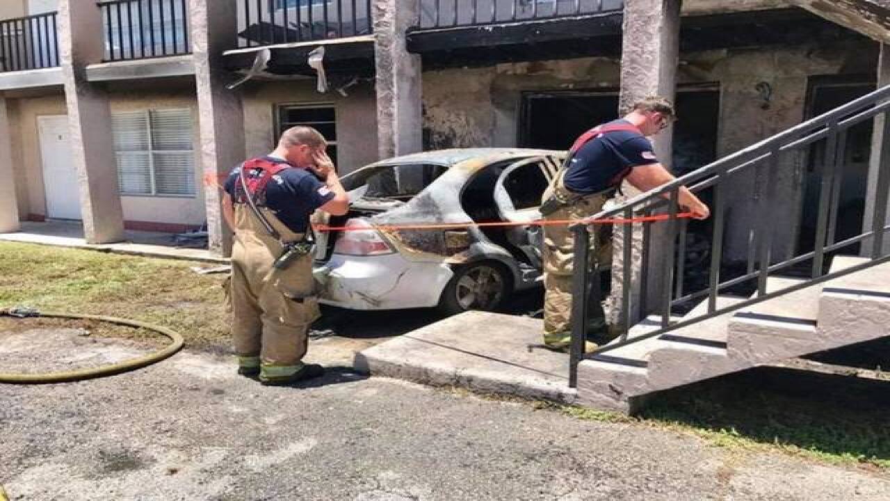 Car packed with propane smashes into apartments