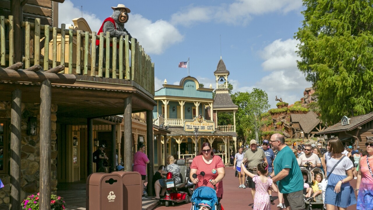People walk around Disney World.