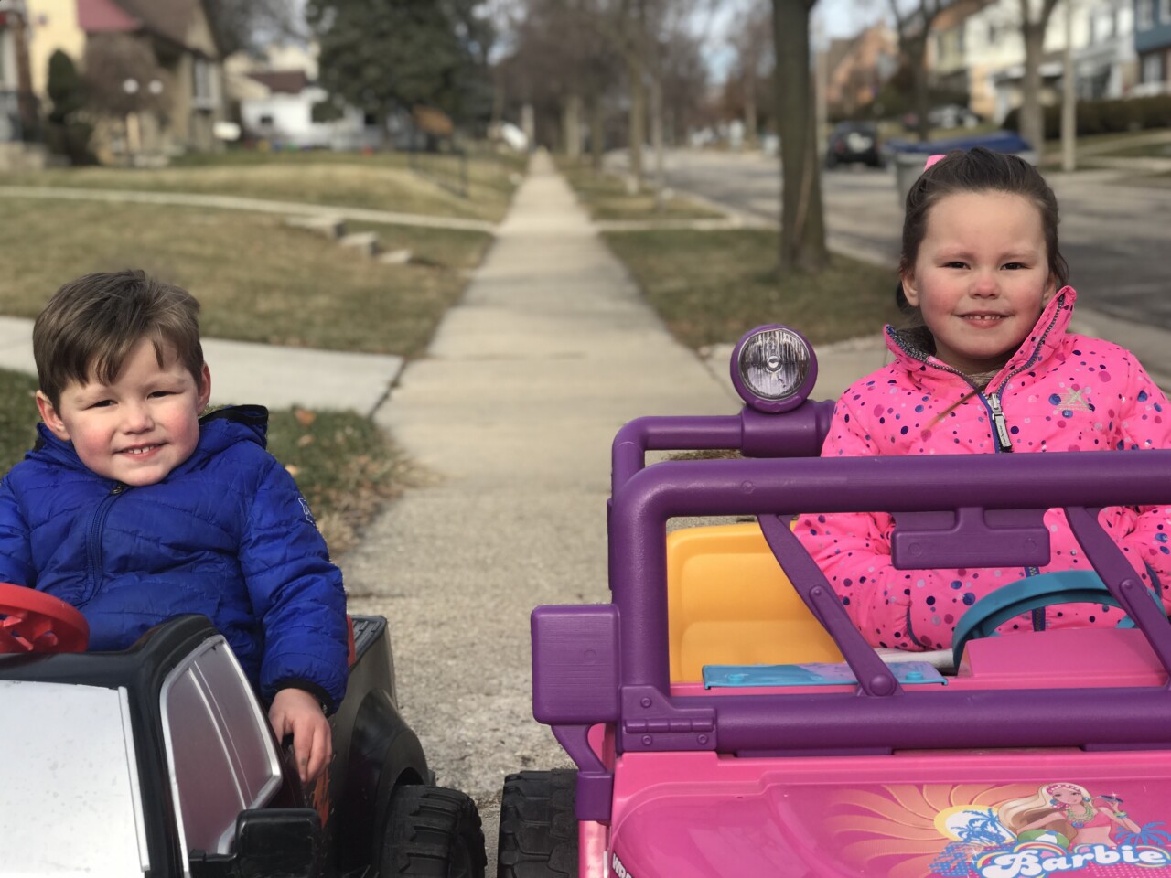 Nico and Lucia Rice drive around in these toy cars with trunks full of rocks to deliver around the neighborhood.