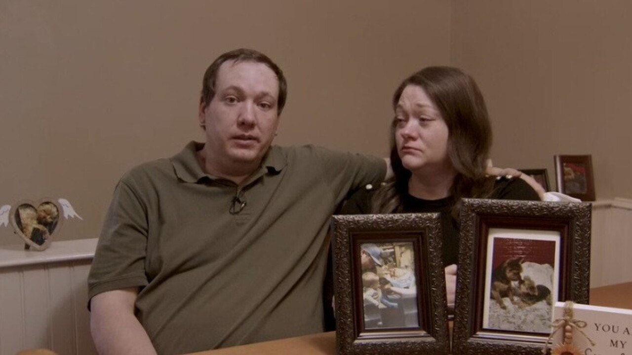The Zylk Family with a photo of their dog.