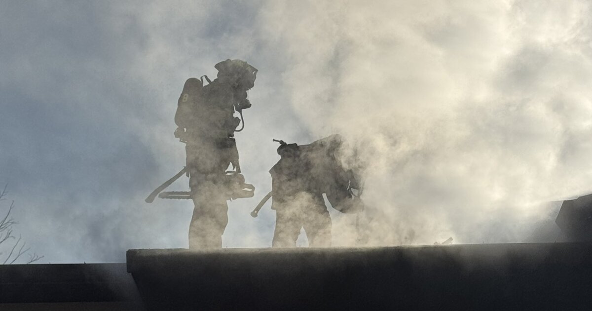 Colorado Springs firefighters work to contain a garage fire in the city