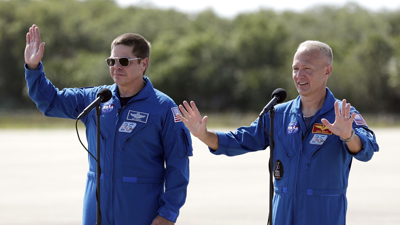 NASA astronauts Bob Behnken and Doug Hurley wave, May 20, 2020