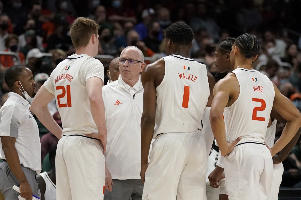 Miami Hurricanes head coach Jim Larranaga talks to players Sam Waardenburg, Anthony Walker and Isaiah Wong, Jan. 22, 2022