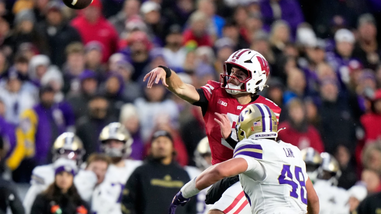 Wisconsin's Carter Smith throws in front of Washington's Jacob Lane during the first half of an NCAA college football game Saturday, Nov. 8, 2025, in Madison. 