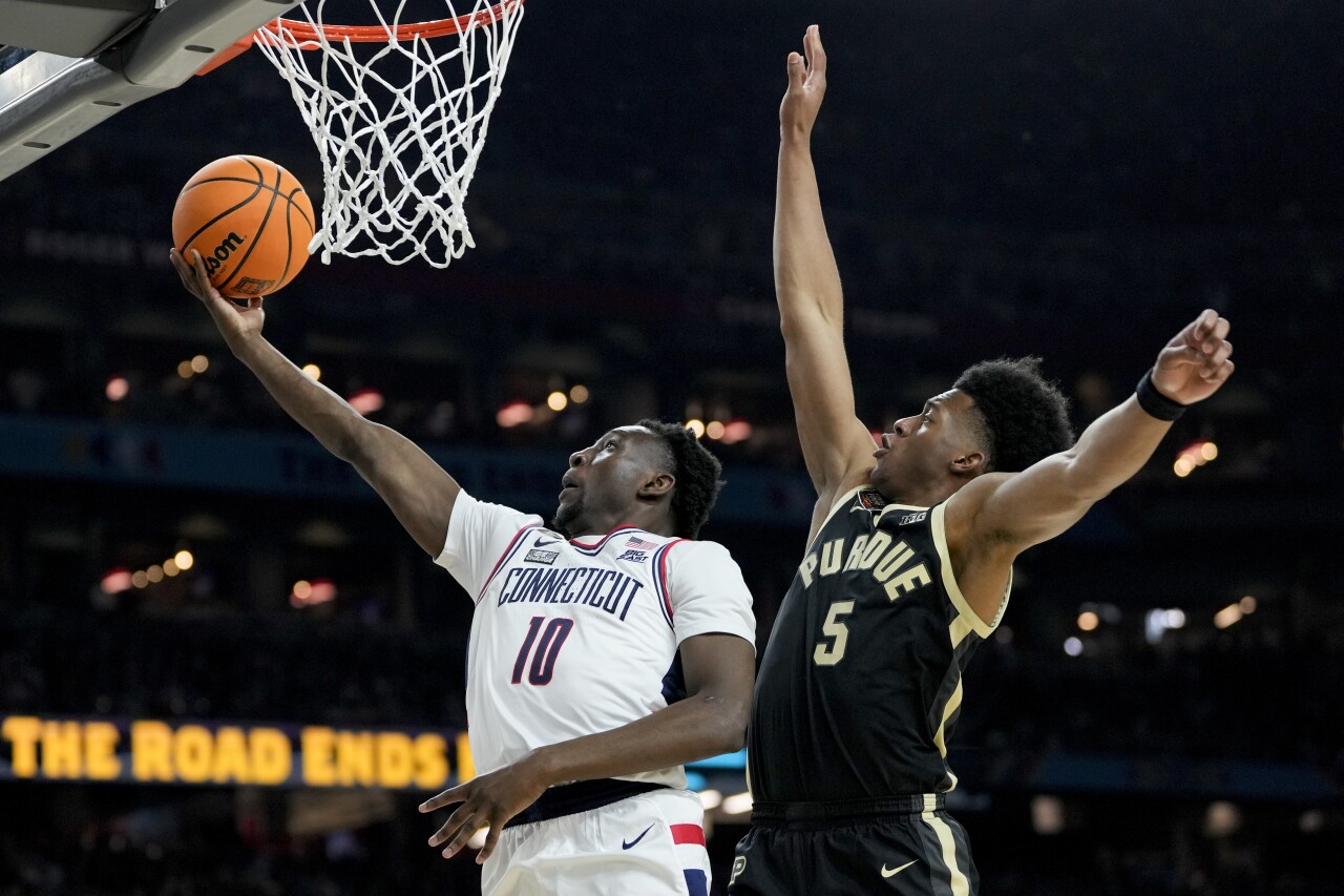 UConn Huskies guard Hassan Diarra scores past Purdue Boilermakers guard Myles Colvin during second half of national championship game, April 8, 2024