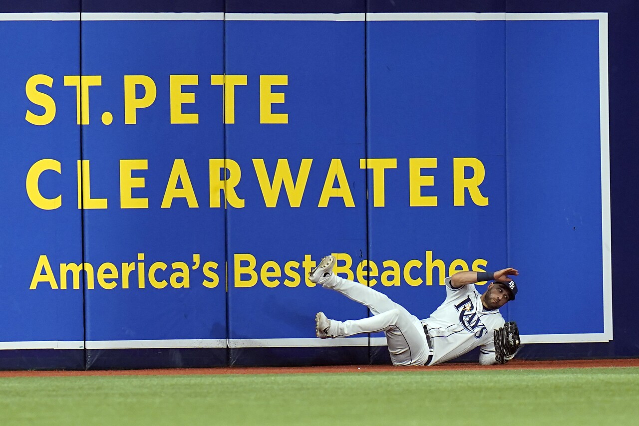Tampa Bay Rays center fielder Kevin Kiermaier makes diving catch in front of 'St. Pete Clearwater America's Best Beaches' sign at Tropicana Field during Game 2 of American League Division Series vs. Boston Red Sox, Oct. 8, 2021