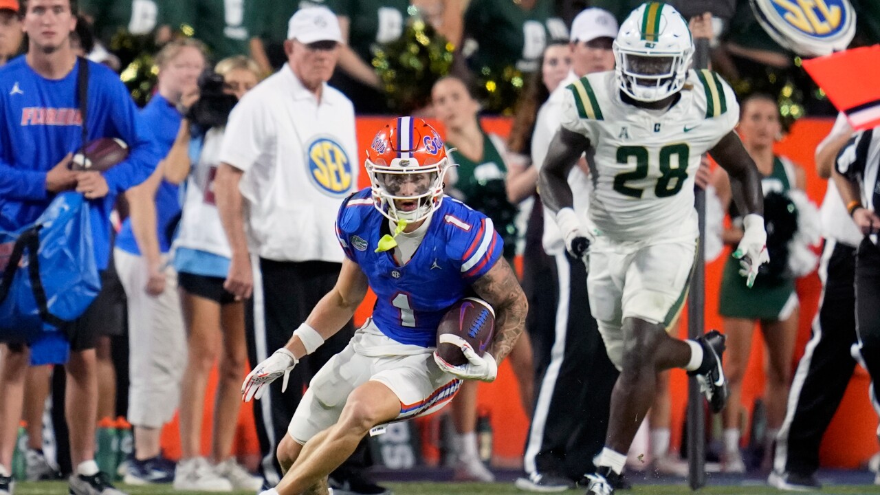 Florida Gators receiver Ricky Pearsall looks for running room after catch as he is chased by Charlotte 49ers linebacker Demetrius Knight II, Sept. 23, 2023