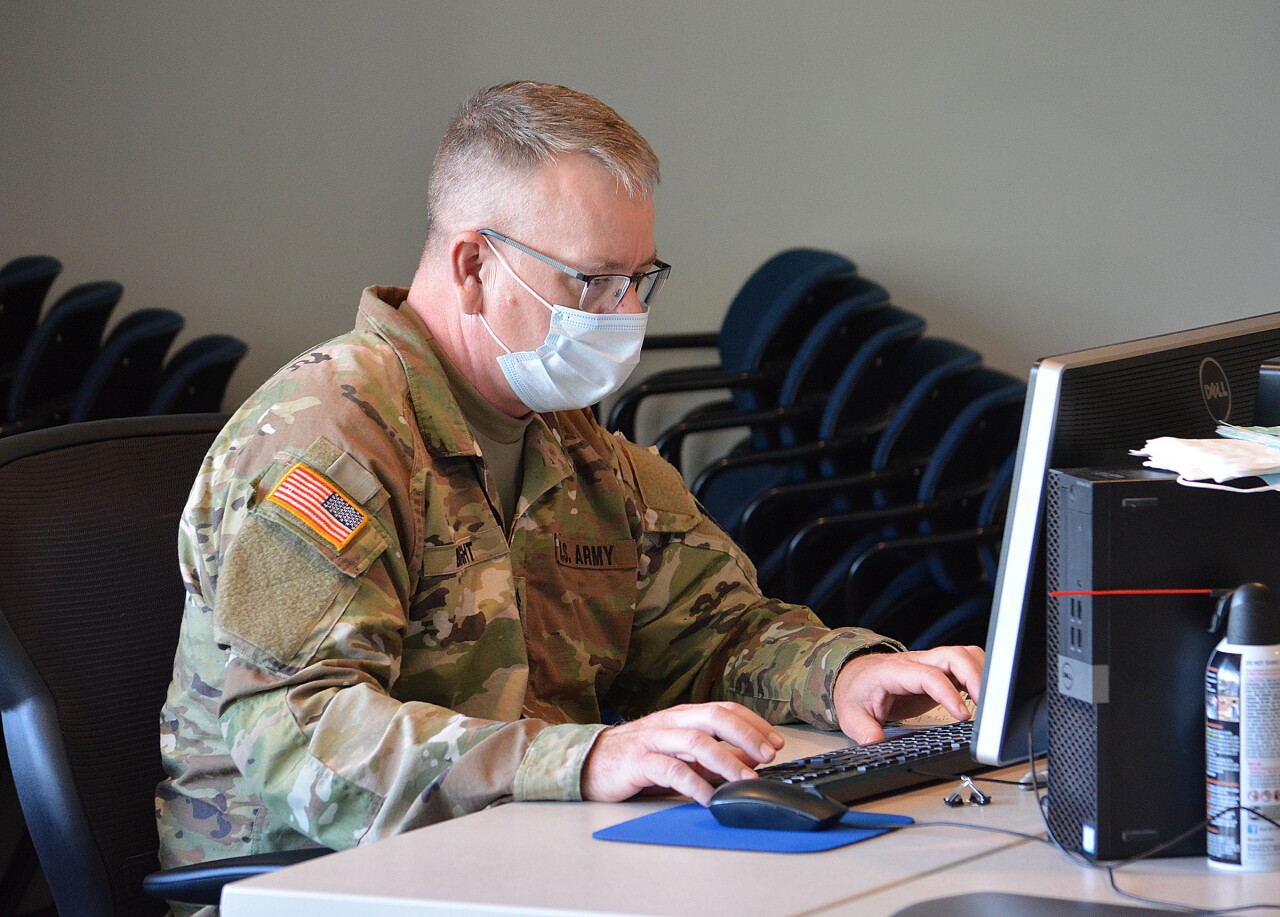 SFC Don Bright helping enter COVID-19 sample data into the computer