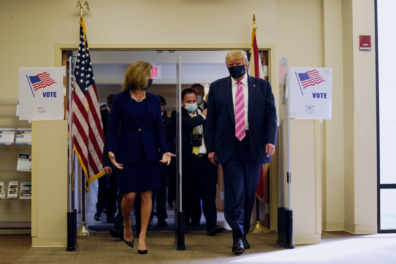 President Donald Trump walks with Wendy Sartory Link after voting in Palm Beach County