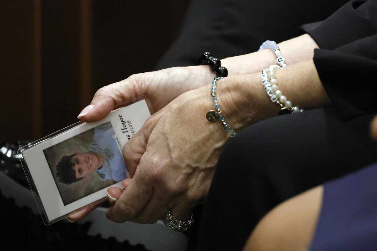 Gena Hoyer holds photo of son Luke Hoyer while awaiting verdict in Nikolas Cruz sentencing trial, Oct. 13, 2022