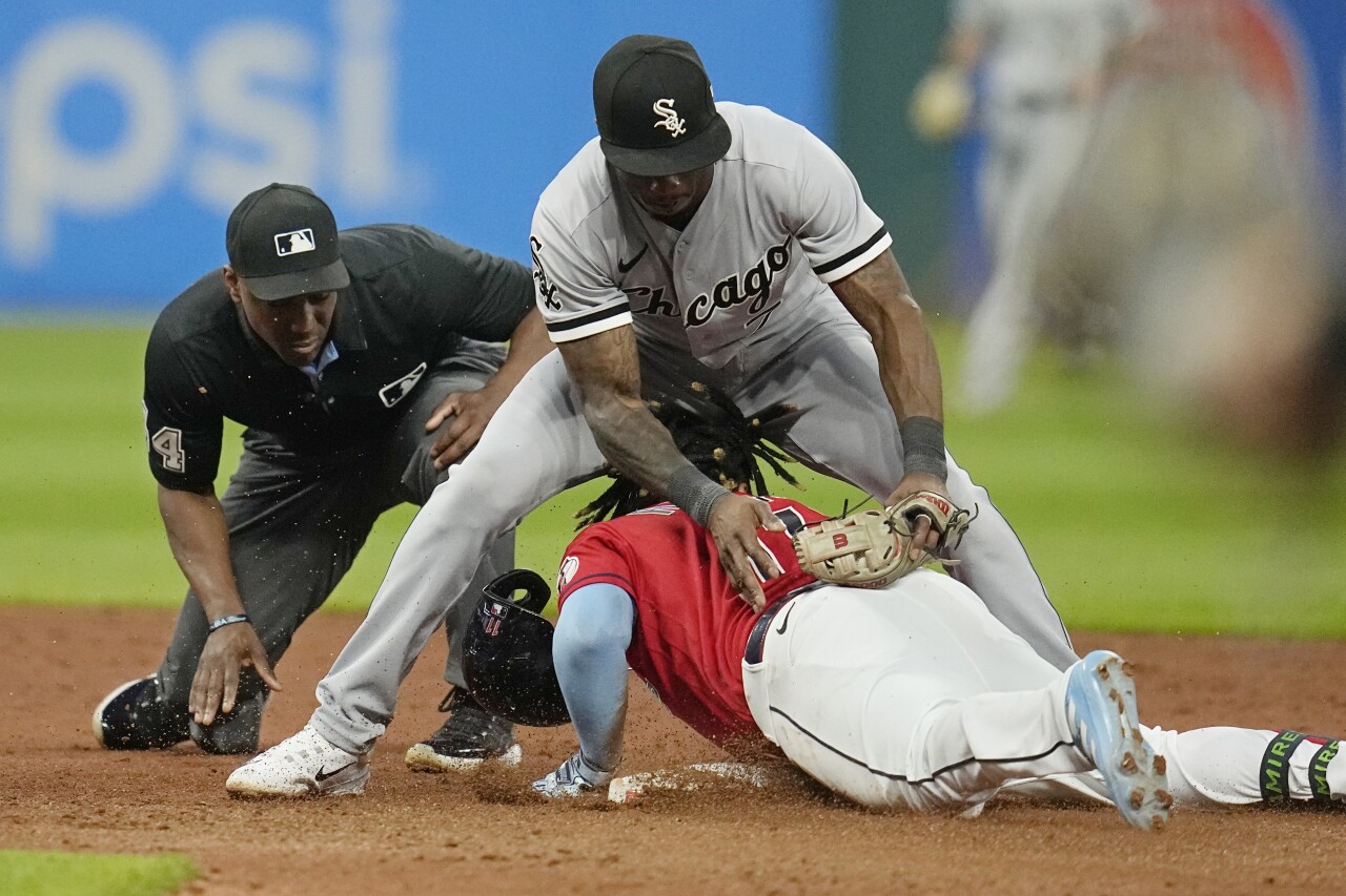 Cleveland Guardians third baseman Jose Ramirez slides under legs of Chicago White Sox shortstop Tim Anderson in sixth inning, Aug. 5, 2023