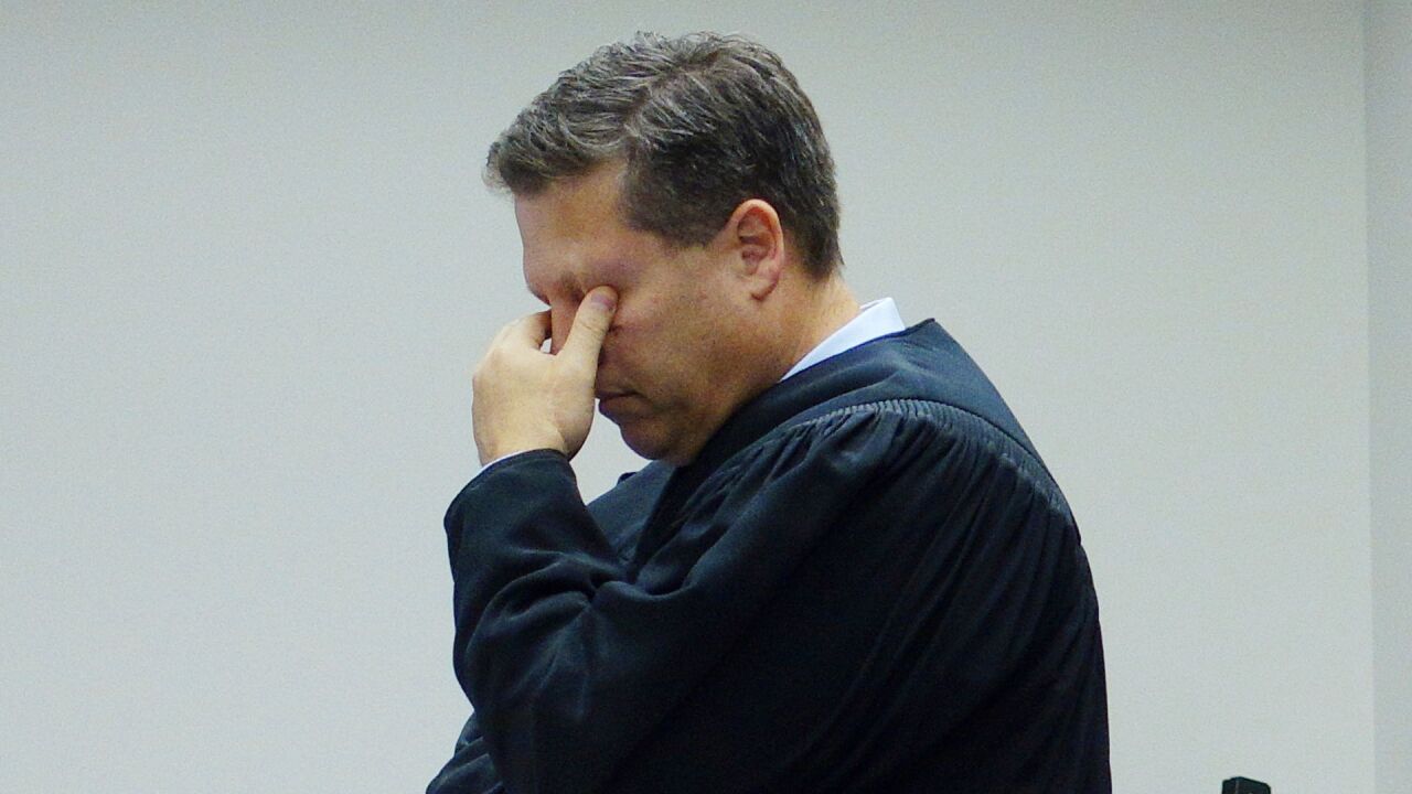 File — King County Superior Court Judge Roger Rogoff pinches his eyes as he stands in court, Monday, Oct. 10, 2016, in Seattle.