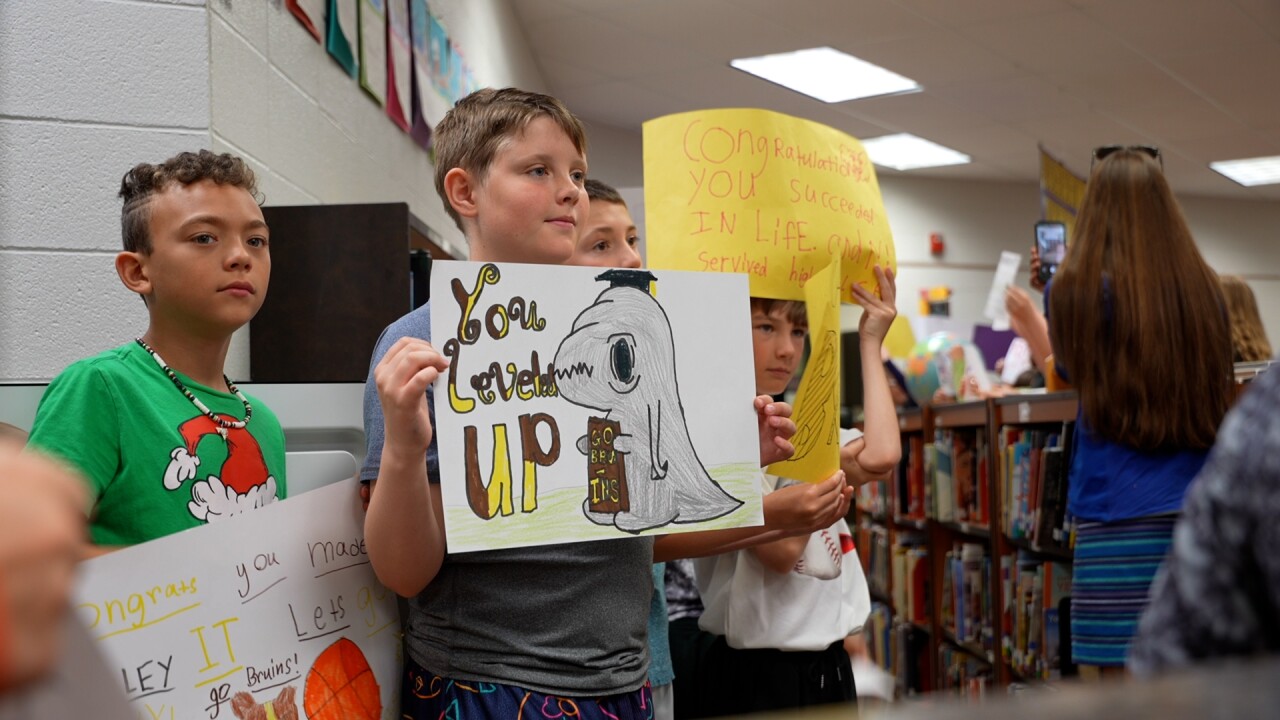 Boys holding signs