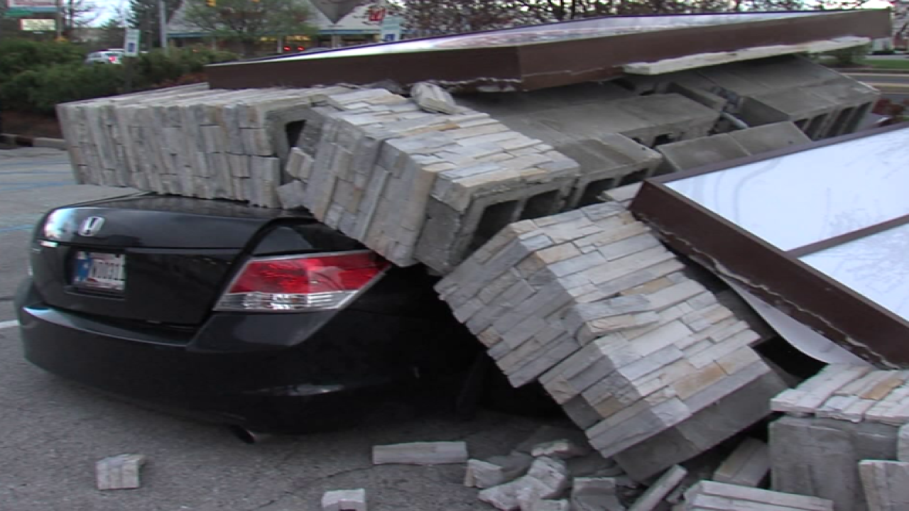 PICS: Sign falls on car, driver gets out