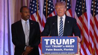 Republican presidential candidate Donald Trump stands with former presidential candidate Ben Carson.