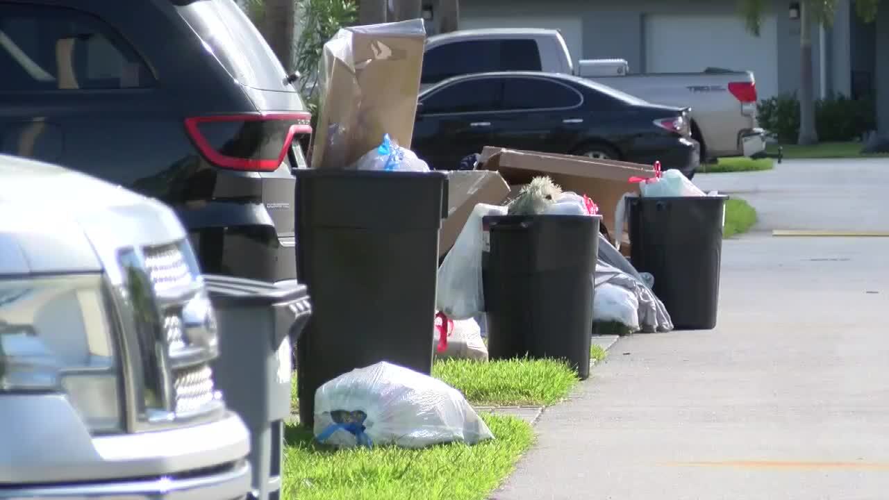 trash piled up outside homes in Port St. Lucie