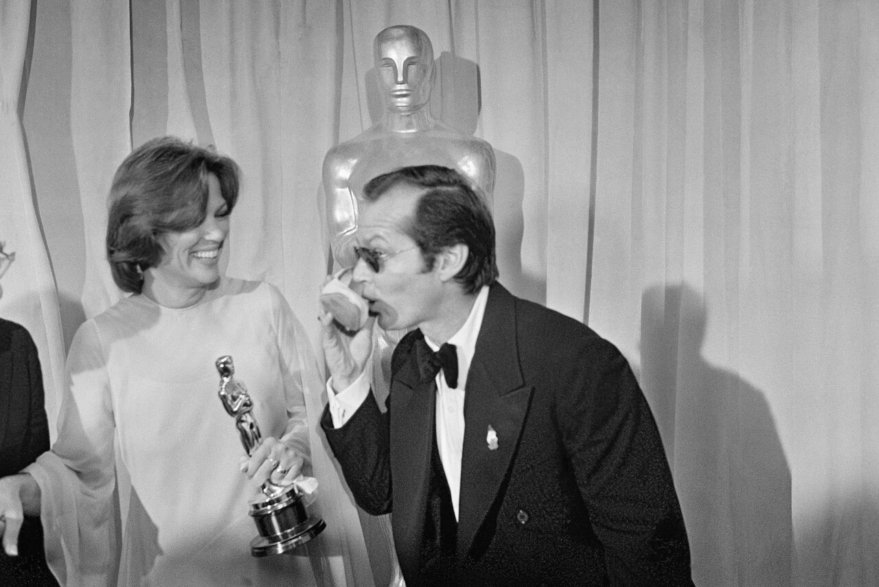 Jack Nicholson pretends to drink from shoe of Louise Fletcher after they won Oscars for 'One Flew Over the Cuckoo's Nest' at 1976 awards