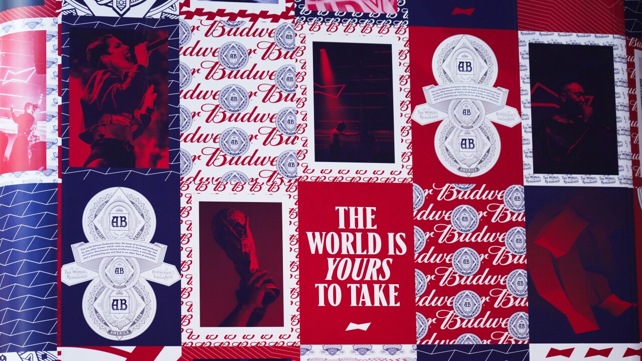 ads for Budweiser beer in Qatar before World Cup with slogan 'The World is Yours to Take'