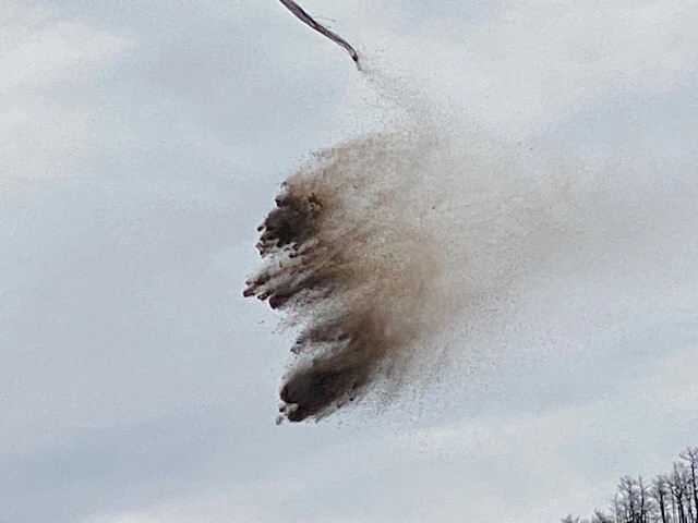 Dropping mulch on mountainside