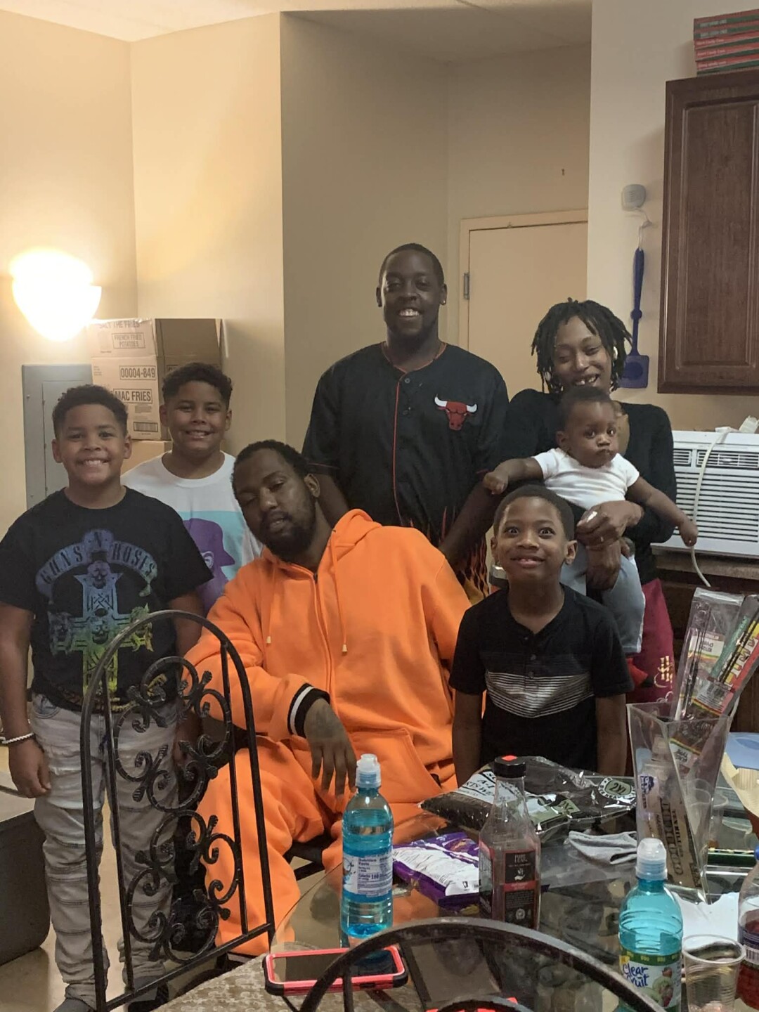 38-year-old Christopher White, center wearing orange; White's family identified him as the victim of a fatal shooting Friday night on the 1000 block of W. Atkinson Avenue.