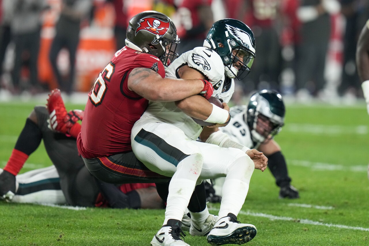 Philadelphia Eagles QB Jalen Hurts sacked by Tampa Bay Buccaneers defensive tackle Greg Gaines in second half of wild-card playoff, Jan. 15, 2024