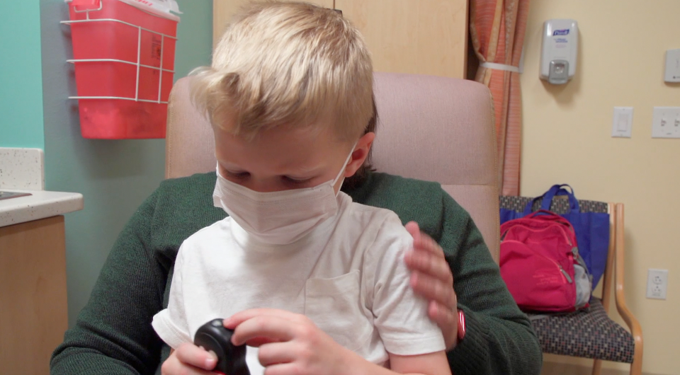 Anne Rodriguez comforting son after COVID-19 vaccination