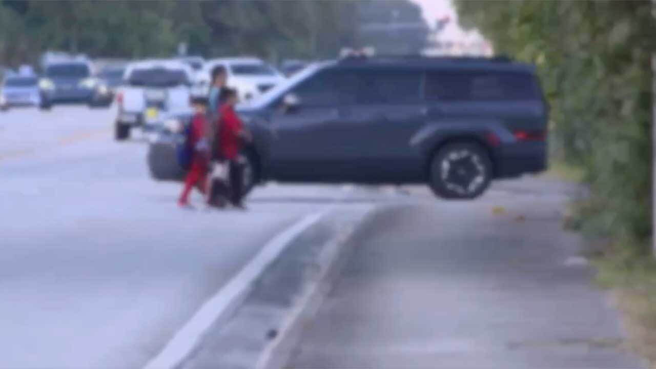 Family crossing near Greenacres Elementary School
