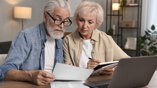 Pension,Savings.,Senior,Couple,Planning,Budget,At,Wooden,Table,Indoors