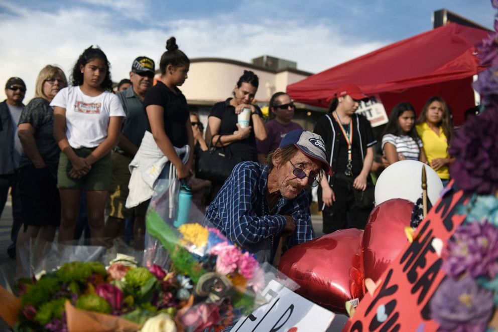 Callaghan OHare/Reuters
Antonio Basco looks at the cross bearing the name of his partner Margie Reckard, who died during the mass shooting at a Walmart store in El Paso, Texas, Aug. 7, 2019.