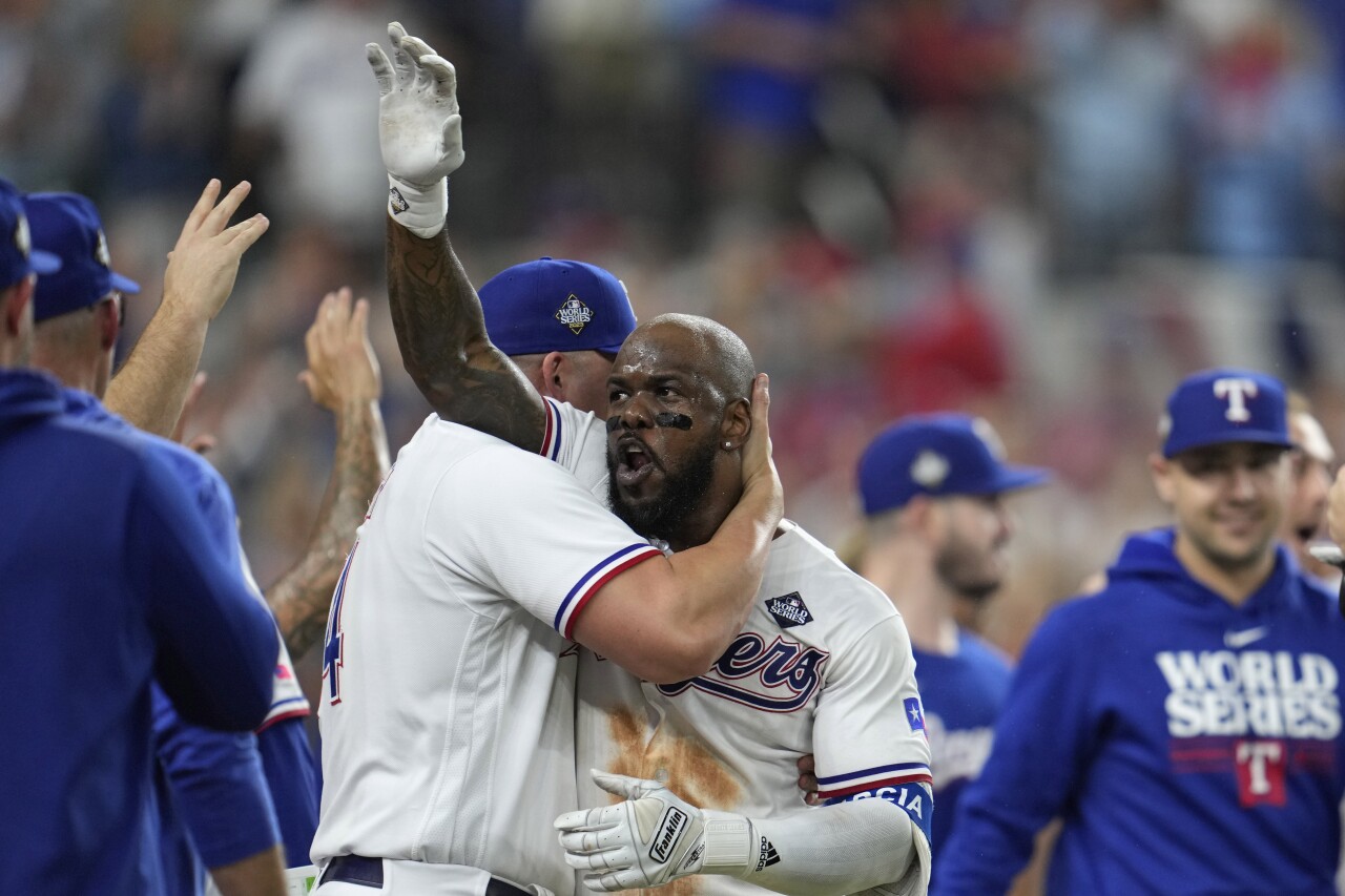 Texas Rangers outfielder Adolis Garcia celebrates with teammates after hitting game-winning home run against Arizona Diamonbacks in World Series opener, Oct. 27, 2023