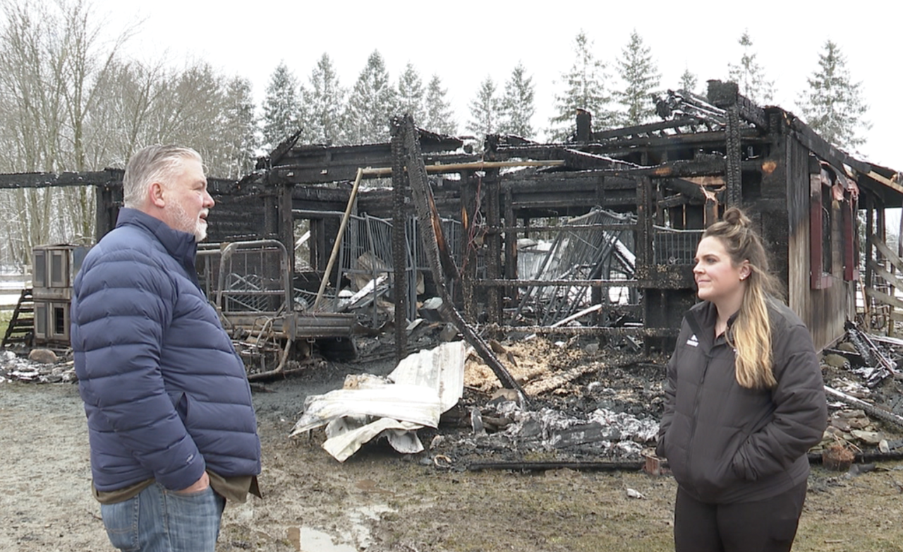Jay Braymiller stands in front of barn