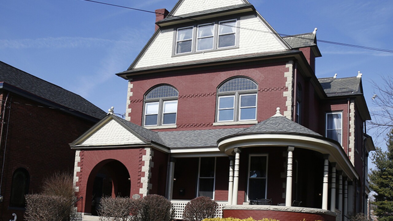 Facade of an unfinished two-story house with no red brick windows