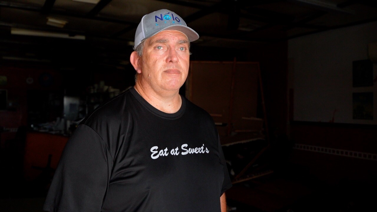 Scott Sweet, the owner of Sweet's Diner, standing in the destroyed dining room.
