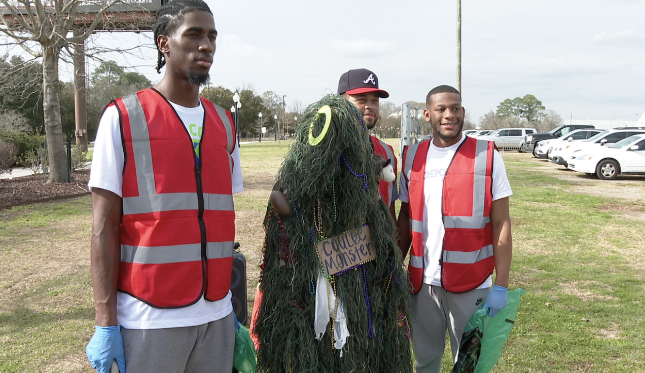 Krewe de Coulee volunteers pose with "Coulee Monster"