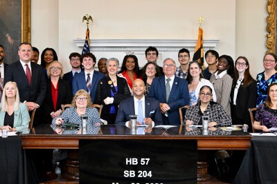 Kinsley, Chris, and elected officials at the bill signing